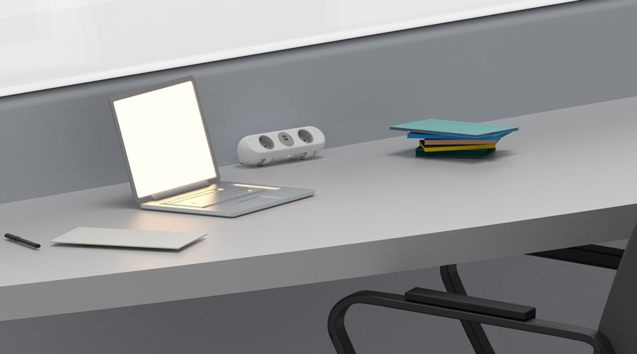 Eine POLARICE auf einem grauen Schreibtisch, umgeben von einem Laptop und einigen Büchern